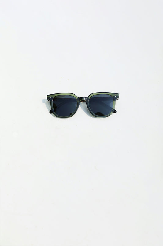 a pair of sunglasses sitting on top of a white surface