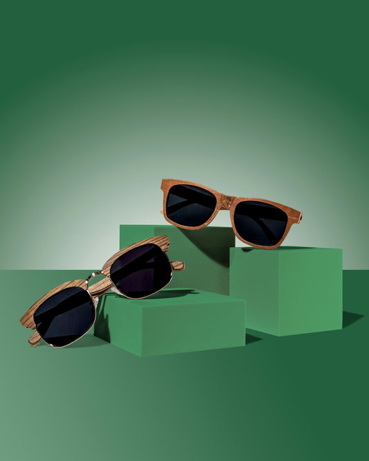 a pair of sunglasses sitting on top of a green box