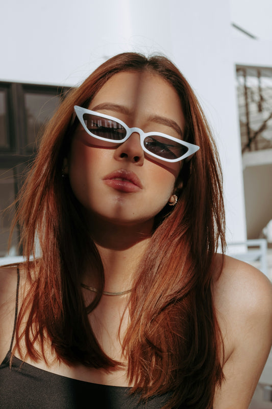 a woman wearing sunglasses and a black top