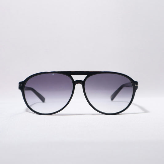 Black aviator sunglasses are sitting on a white background.